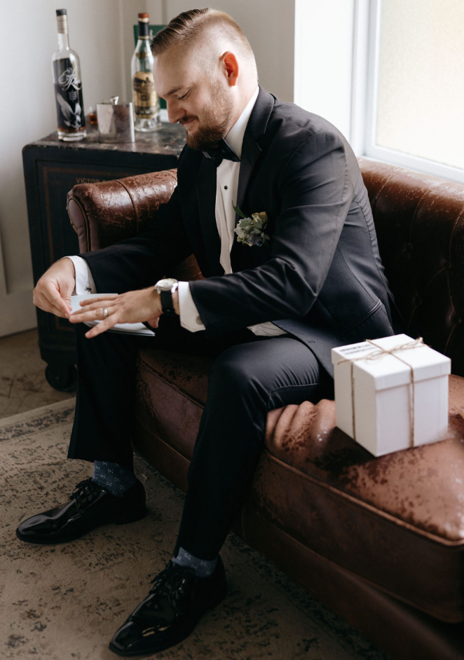 Groom reading letter from bride on day of wedding